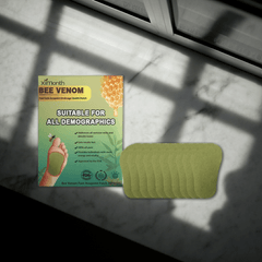 Detox foot patch packaging next to patches on a surface, promotes detoxifying and revitalizing feet.
