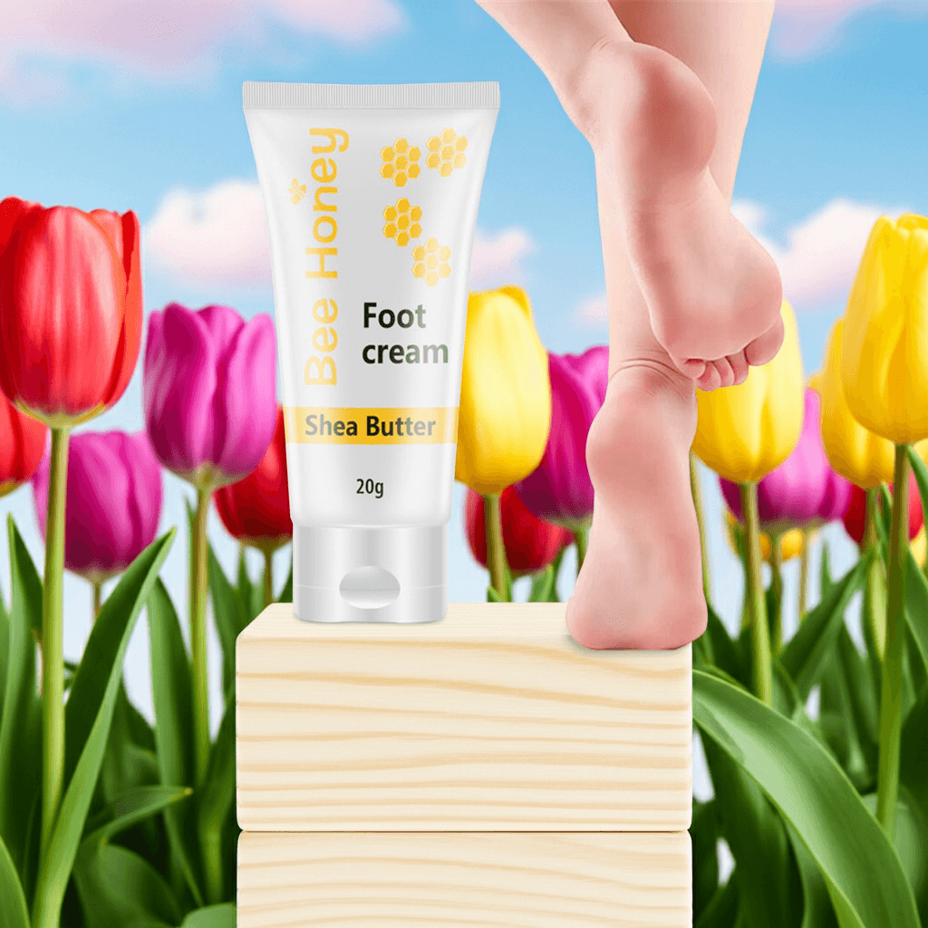 Honey foot repair cream displayed with a bare foot on a wooden block surrounded by colorful tulips.