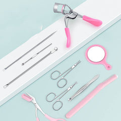 Makeup tools and accessories set including eyelash curler, scissors, tweezers, and mirror on a pastel background.
